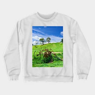 Old agricultural machinery in a field Crewneck Sweatshirt